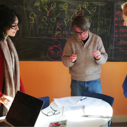 three people talking at a table