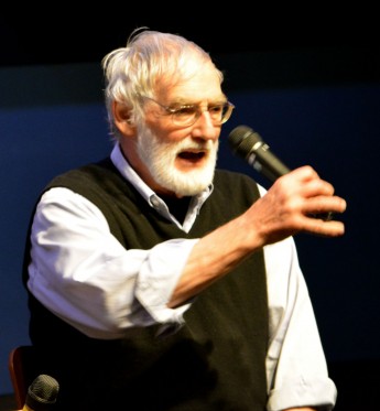 Dr. Dennis Meadows gestures with a microphone